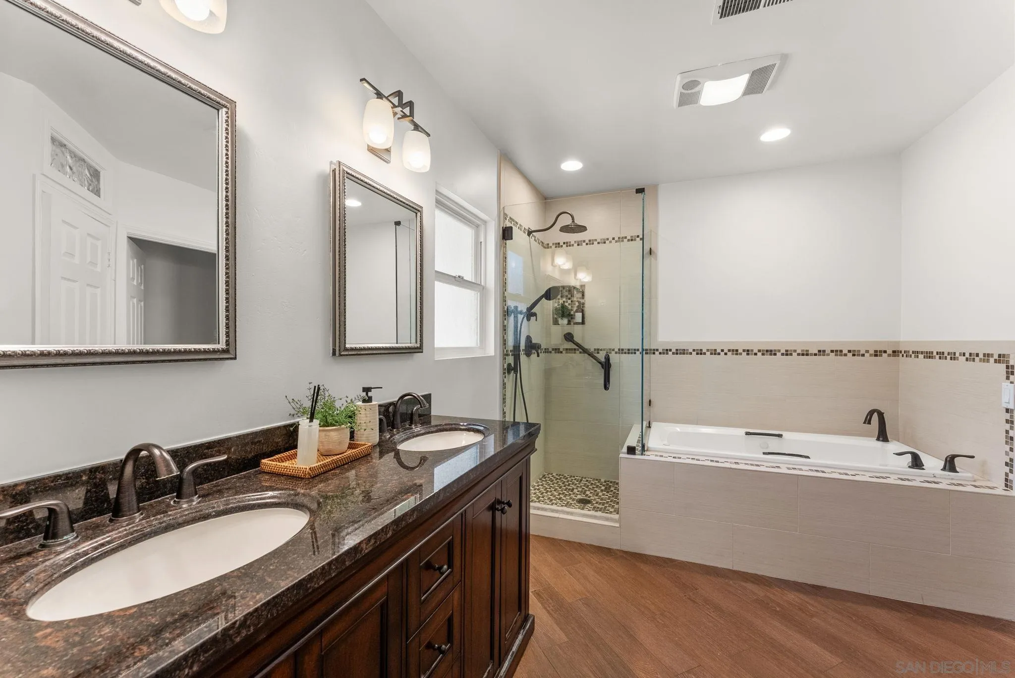 12832 Stone Canyon Road Poway, CA 92064 - Photo 29 of 60 a bathroom with a granite countertop sink mirror and a