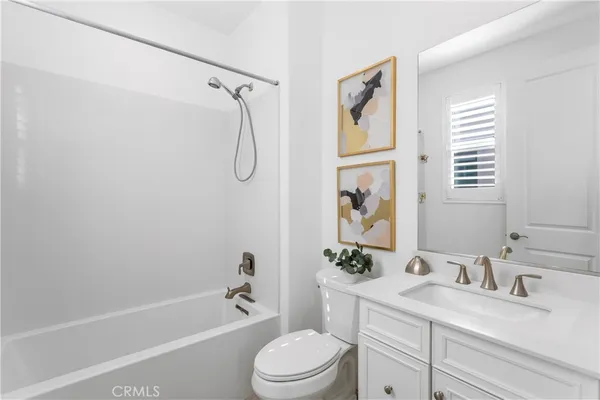 a bathroom with a granite countertop sink toilet tub and shower