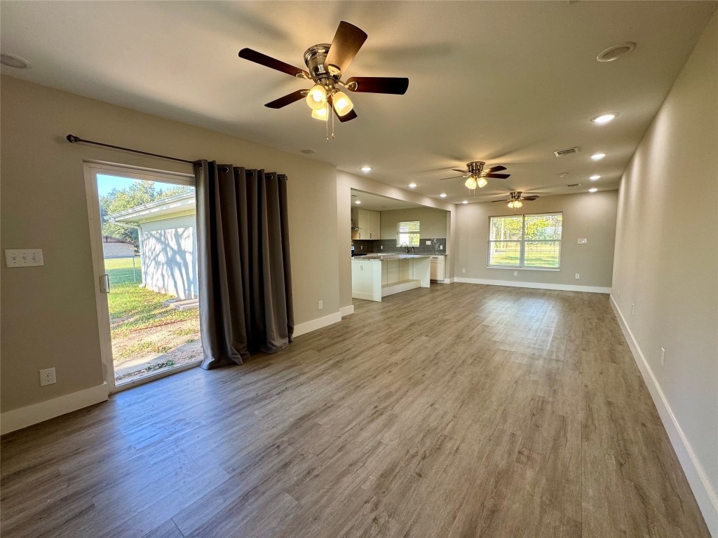 813 Central Avenue Elgin, TX 78621 - Photo 10 of 26 wooden floor in an empty room with a window