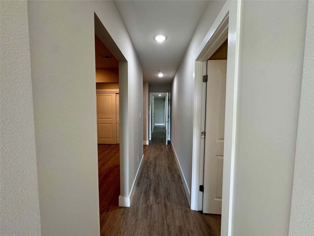 813 Central Avenue Elgin, TX 78621 - Photo 16 of 26 a view of a hallway with wooden floor