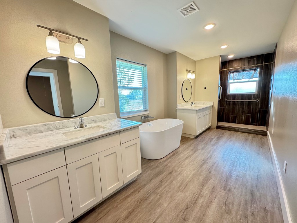 813 Central Avenue Elgin, TX 78621 - Photo 18 of 26 a bathroom with a granite countertop sink mirror vanity and toilet