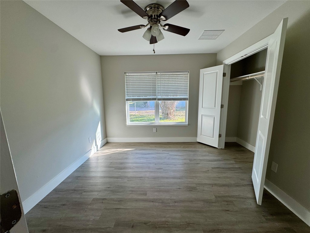 813 Central Avenue Elgin, TX 78621 - Photo 22 of 26 wooden floor in an empty room with a window