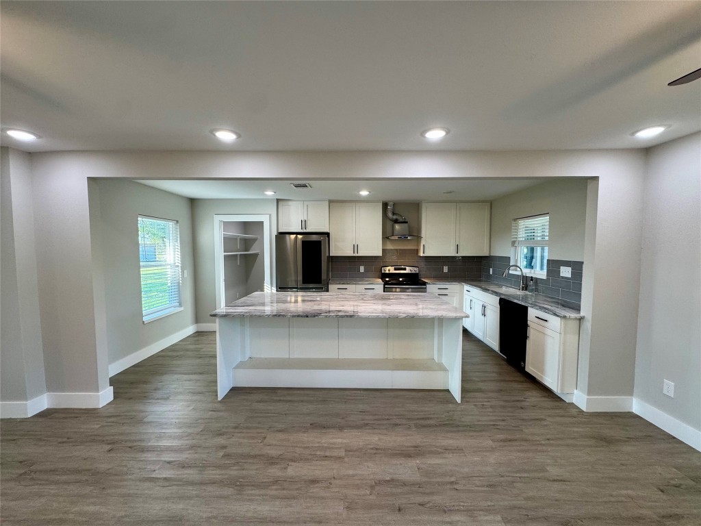 813 Central Avenue Elgin, TX 78621 - Photo 7 of 26 a view of kitchen with cabinets microwave and stove