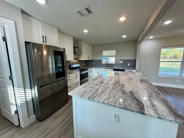 a kitchen with a stove and a refrigerator