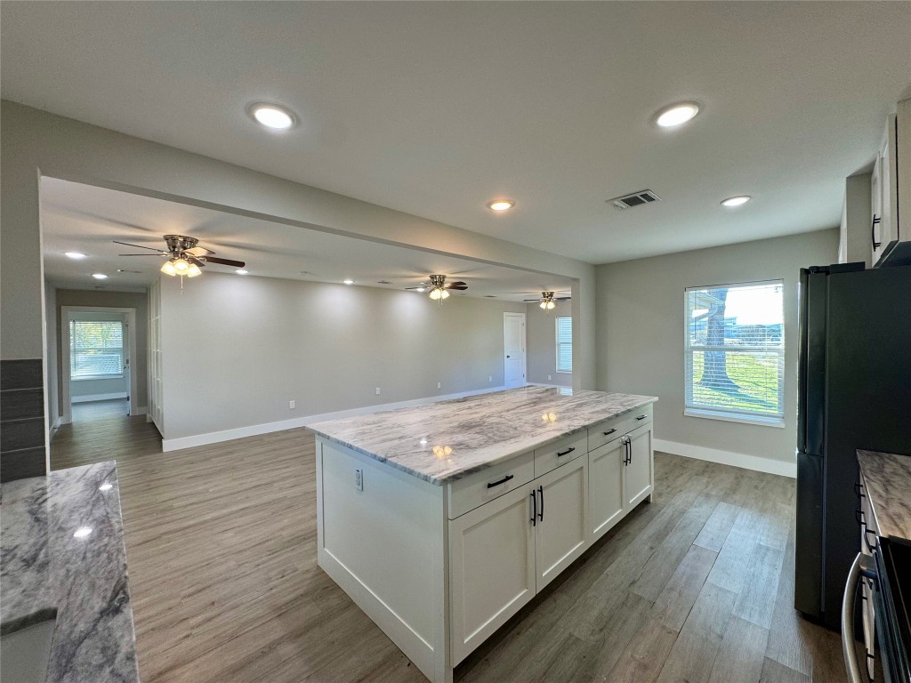 813 Central Avenue Elgin, TX 78621 - Photo 26 of 26 a kitchen with a stove and a refrigerator