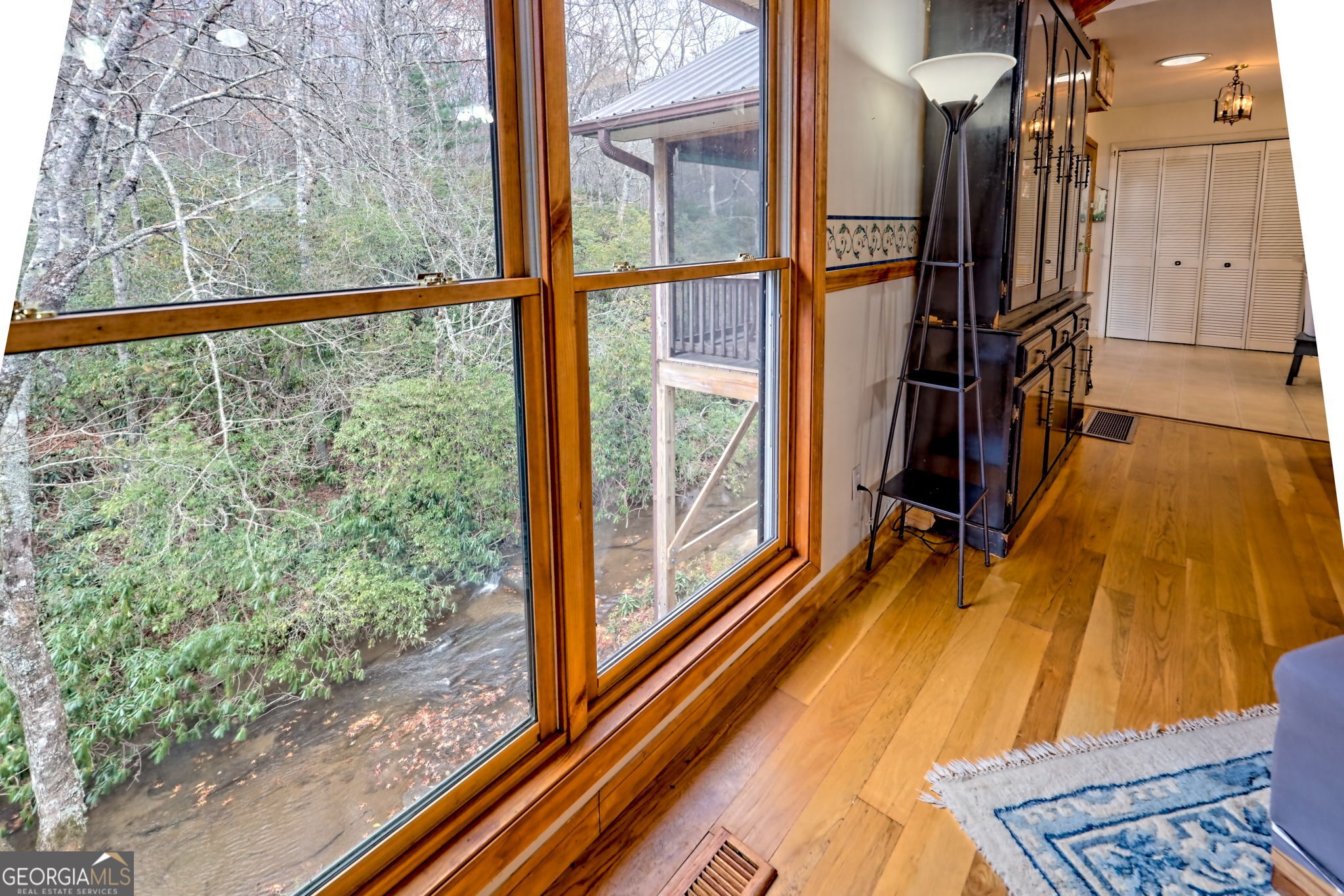 7829 Dillard Road Scaly Mountain, NC 28775 - Photo 15 of 97 a view of a balcony with wooden floor and door