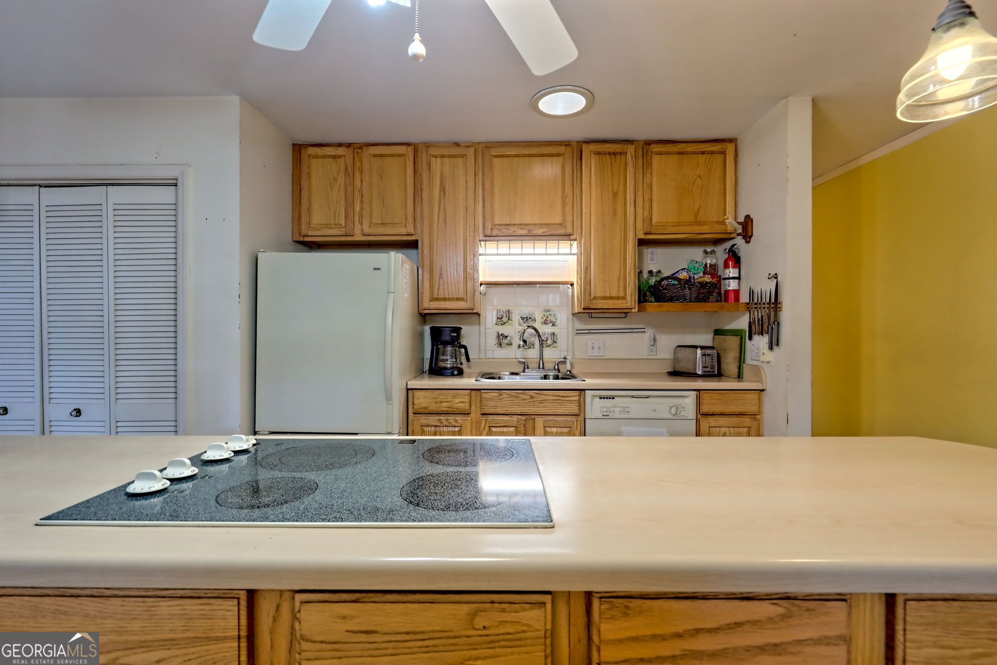 7829 Dillard Road Scaly Mountain, NC 28775 - Photo 19 of 97 a kitchen with kitchen island granite countertop a sink and a refrigerator