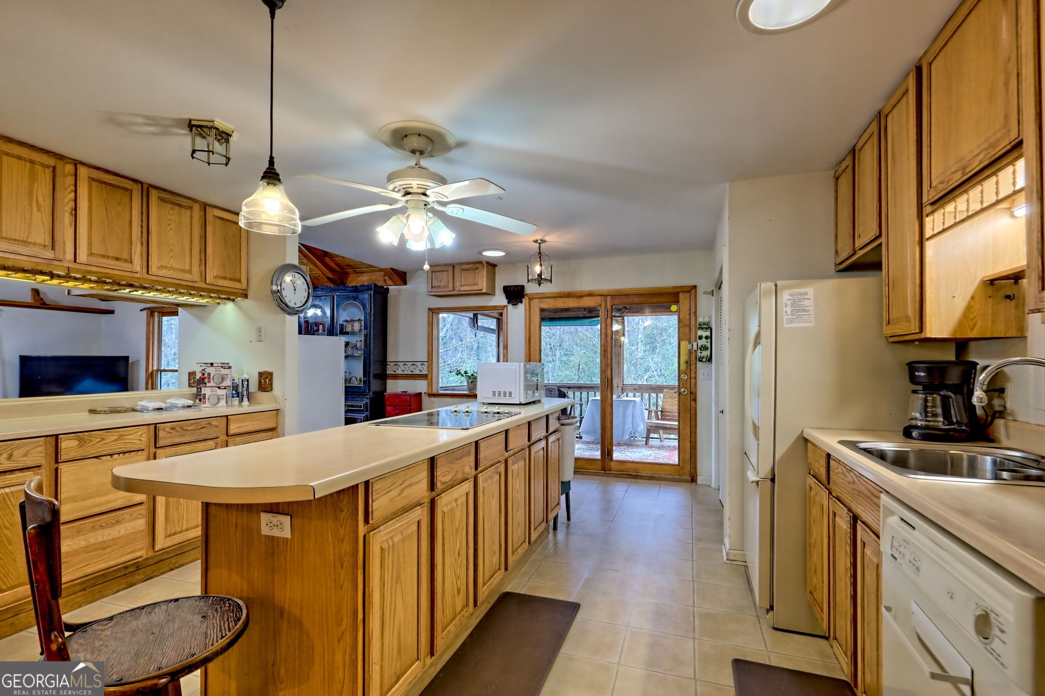 7829 Dillard Road Scaly Mountain, NC 28775 - Photo 21 of 97 a kitchen with stainless steel appliances a stove a sink a refrigerator cabinets and a dining table