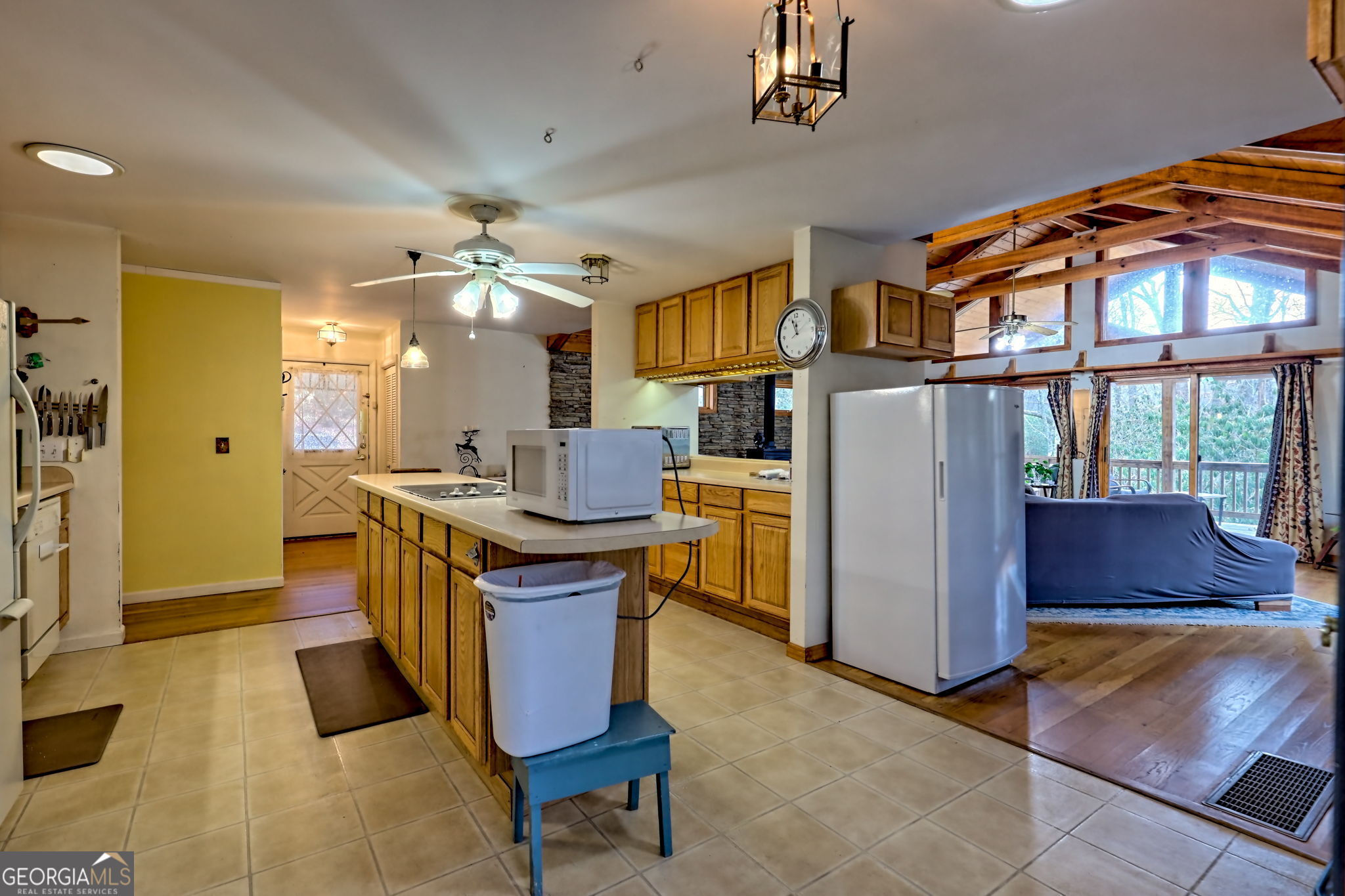 7829 Dillard Road Scaly Mountain, NC 28775 - Photo 25 of 97 a kitchen with stainless steel appliances granite countertop a refrigerator a sink dishwasher a dining table and chairs with wooden floor