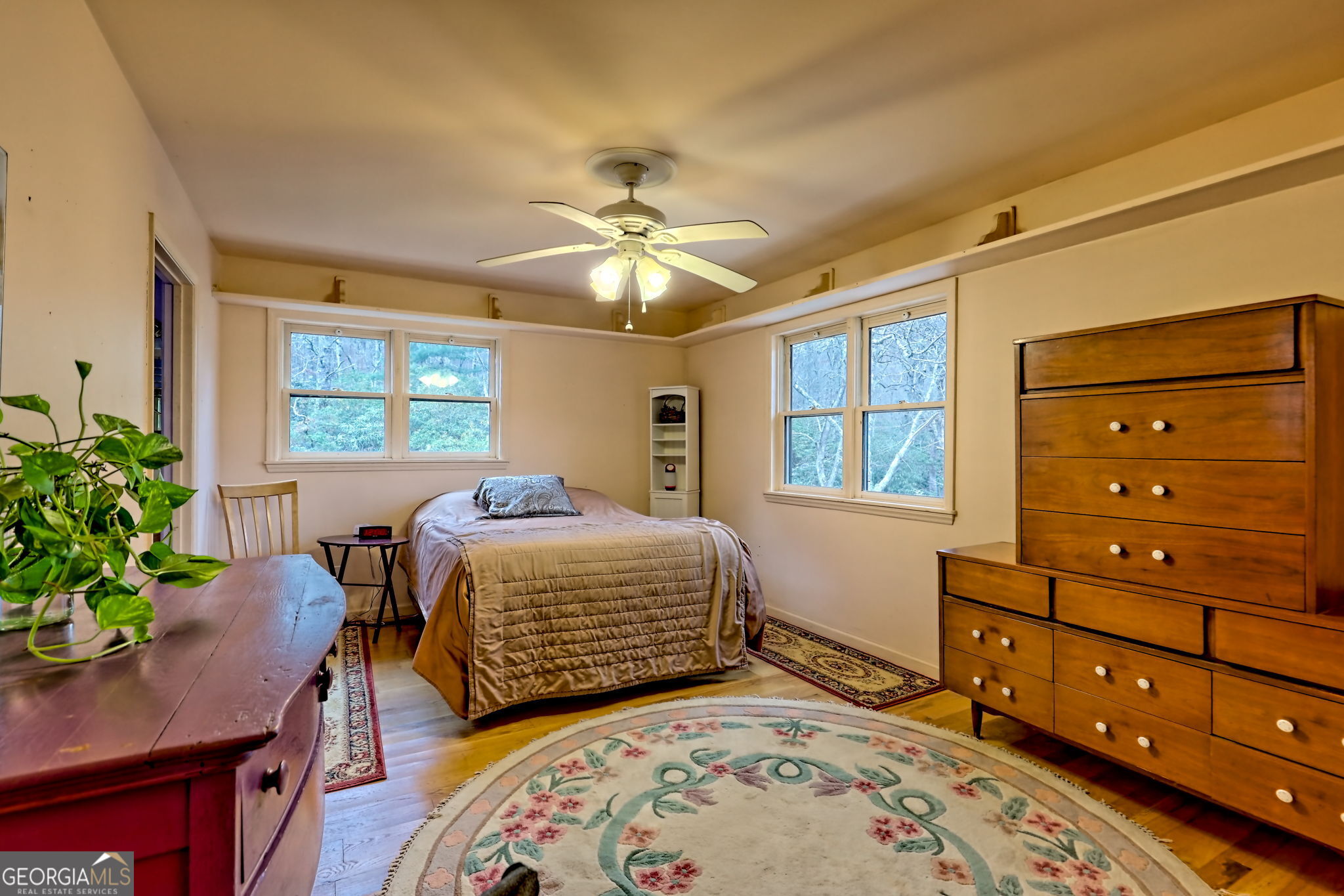 7829 Dillard Road Scaly Mountain, NC 28775 - Photo 27 of 97 a bedroom with a bed and a table in it