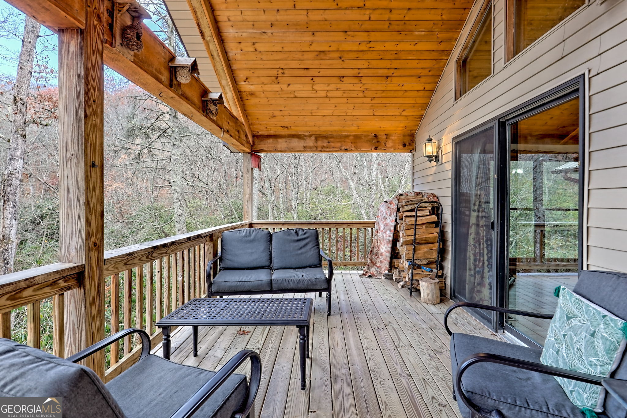 7829 Dillard Road Scaly Mountain, NC 28775 - Photo 45 of 97 a balcony with wooden floor outdoor seating and furniture