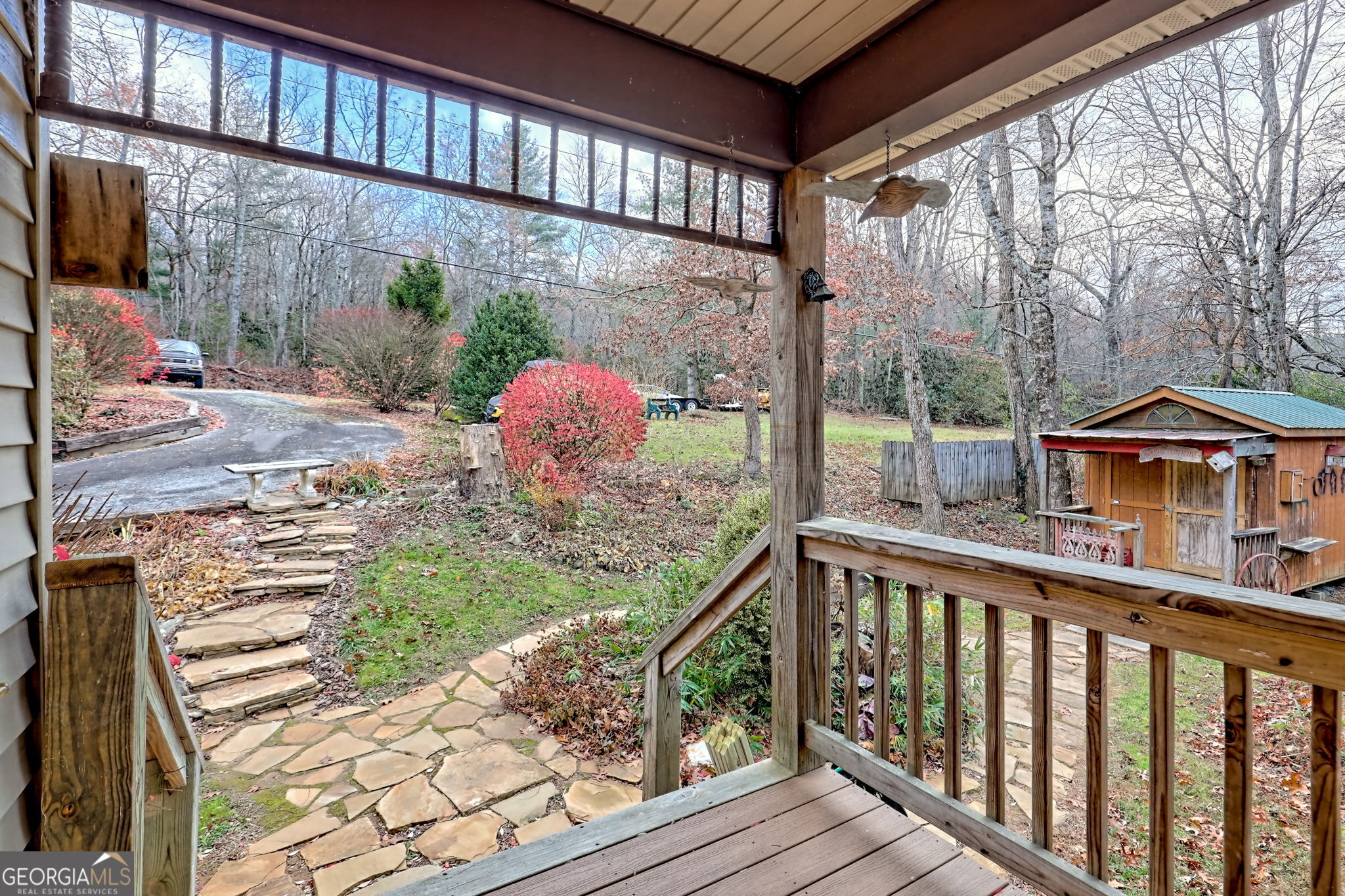 7829 Dillard Road Scaly Mountain, NC 28775 - Photo 47 of 97 a view of a porch with a floor to ceiling window next to a yard