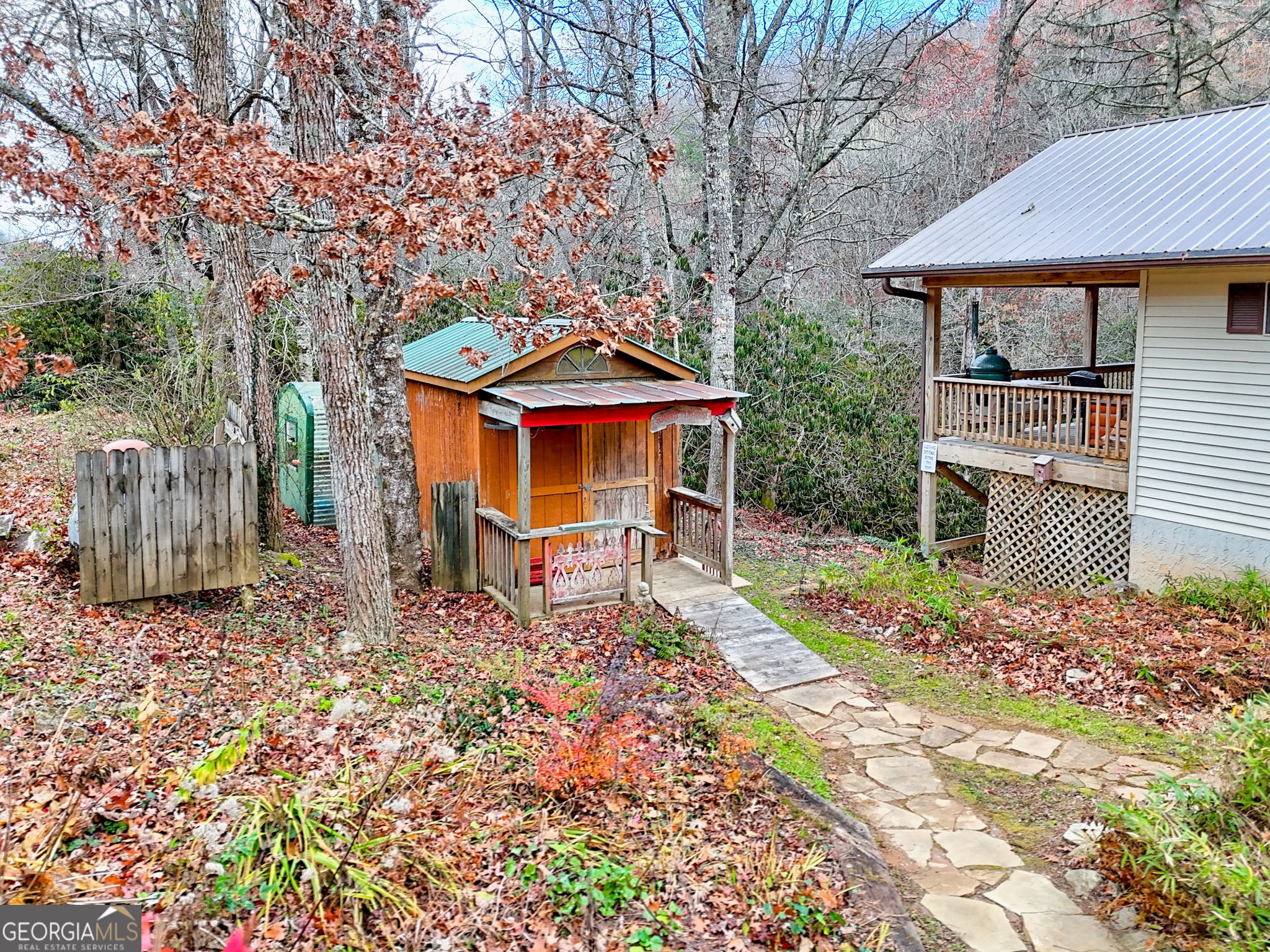7829 Dillard Road Scaly Mountain, NC 28775 - Photo 71 of 97 a patio with a table and chairs under an umbrella