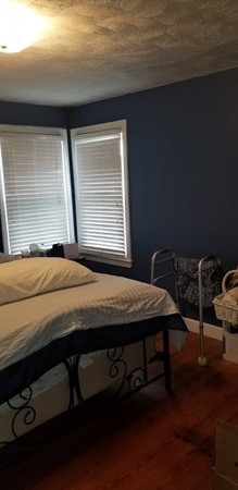 43 Sargon Street Springfield, MA 01104 - Photo 10 of 25 a bed sitting in a bedroom next to a window