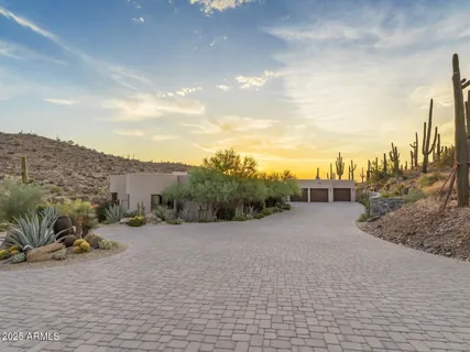 a large white kitchen with a sink and furniture