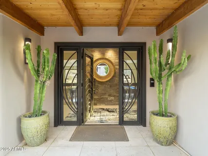 a living room with furniture and large windows