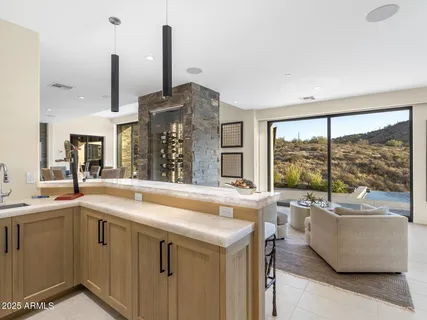 a bedroom with furniture and a large window