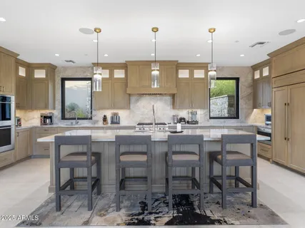 a living room with furniture and floor to ceiling windows
