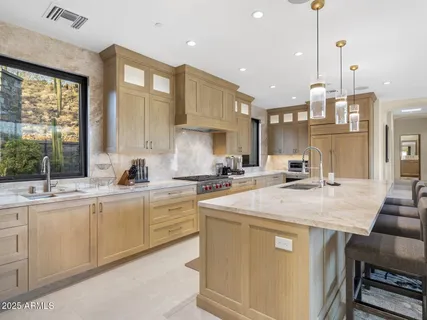 a kitchen with granite countertop a sink and a stove
