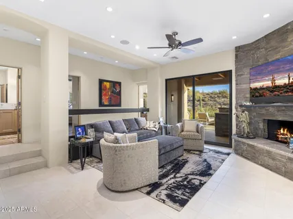 a view of a roof deck with couches under an umbrella