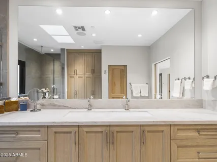 a bathroom with a granite countertop double vanity sinks and a mirror