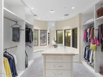 a bathroom with a granite countertop double vanity and a sink