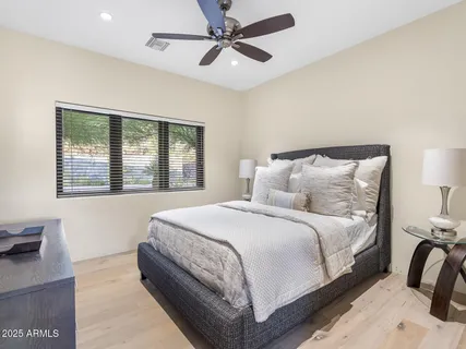 a bedroom with a bed and wooden floor