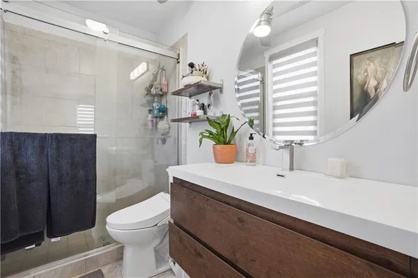 a bathroom with a sink a toilet and shower