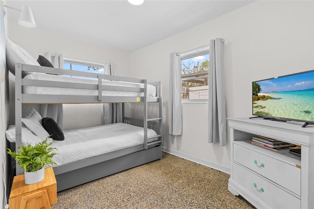 4939 100th Way North St. Petersburg, FL 33708 - Photo 26 of 43 a bedroom with a bed and a flat screen tv