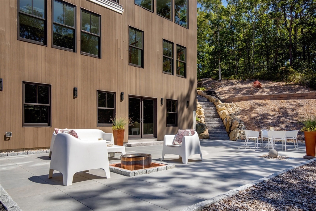 1924R State Road Plymouth, MA 02360 - Photo 38 of 41 a view of a patio with table and chairs potted plants and large tree
