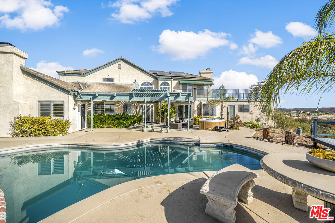 38675 Green Meadow Road Temecula, CA 92592 - Photo 16 of 74 a view of a house with pool and chairs
