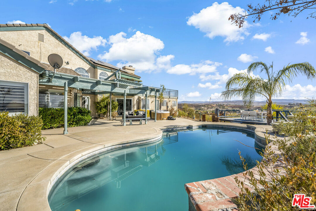 38675 Green Meadow Road Temecula, CA 92592 - Photo 17 of 74 a view of a swimming pool with outdoor seating