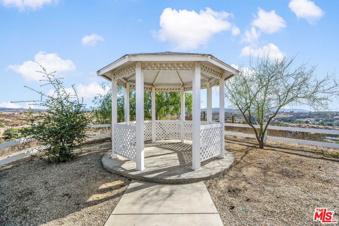 38675 Green Meadow Road Temecula, CA 92592 - Photo 30 of 74 a view of a house with a large tree and a yard