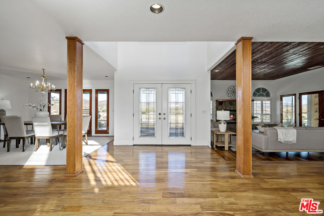 38675 Green Meadow Road Temecula, CA 92592 - Photo 37 of 74 a view of a living room and kitchen with furniture and floor to ceiling window