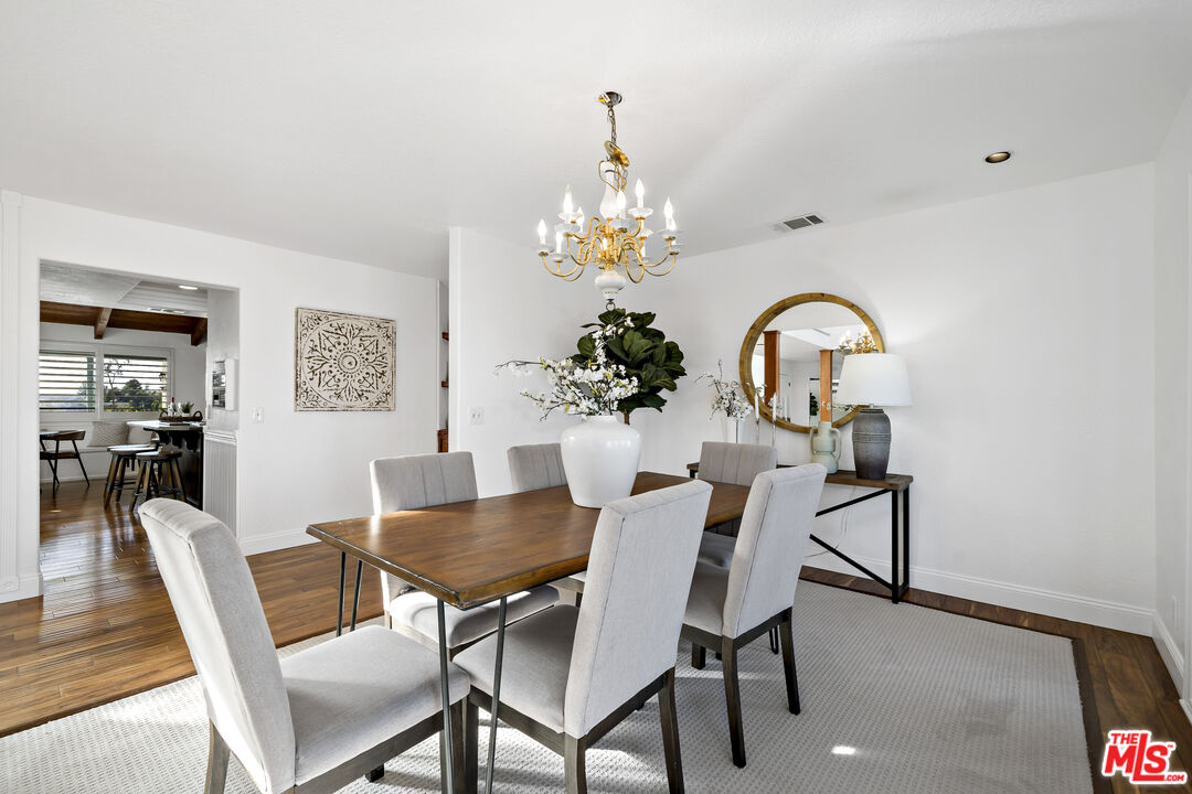 38675 Green Meadow Road Temecula, CA 92592 - Photo 39 of 74 a dining room with furniture potted plants and wooden floor