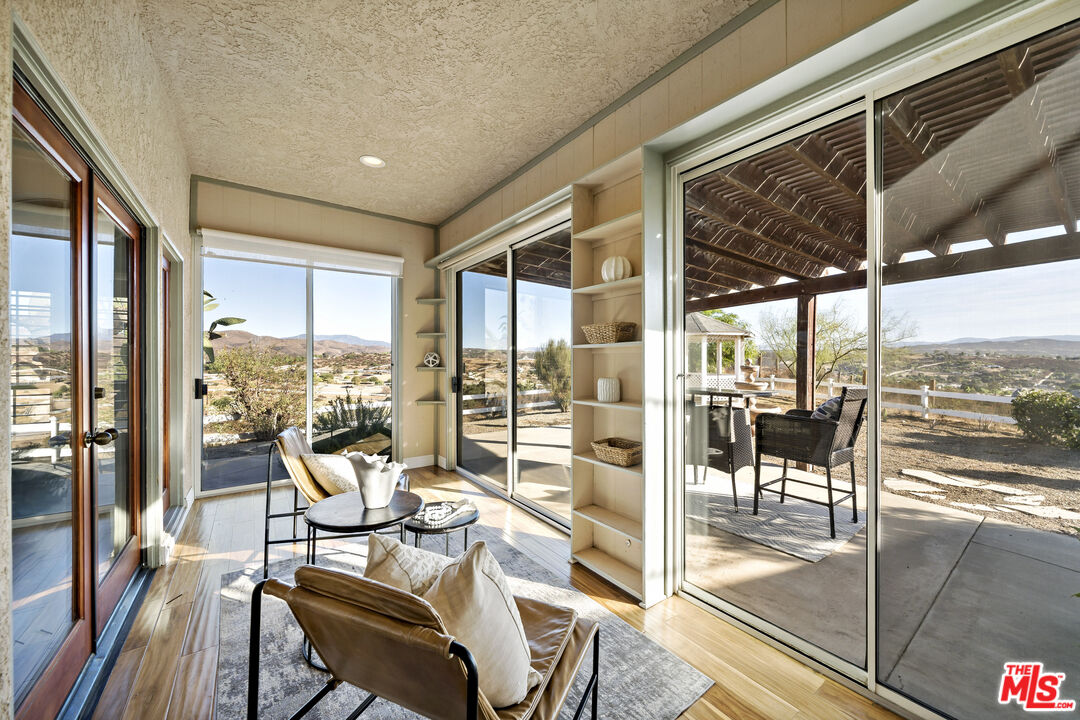 38675 Green Meadow Road Temecula, CA 92592 - Photo 45 of 74 a living room with hardwood floor and iron view