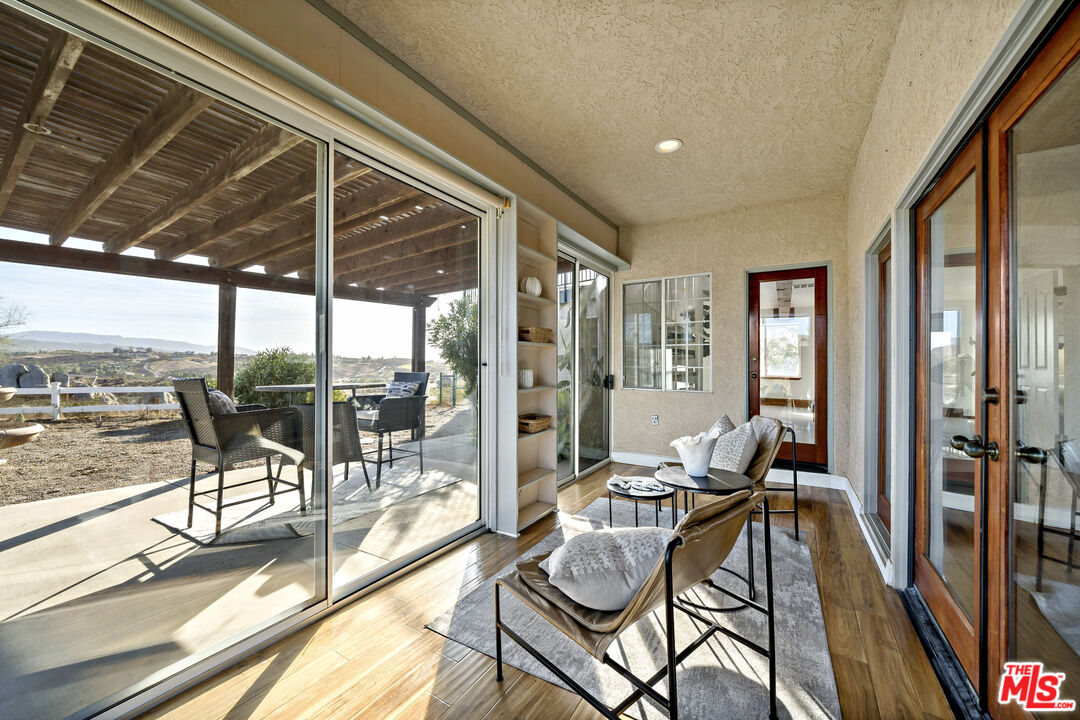 38675 Green Meadow Road Temecula, CA 92592 - Photo 46 of 74 a living room with furniture and a floor to ceiling window