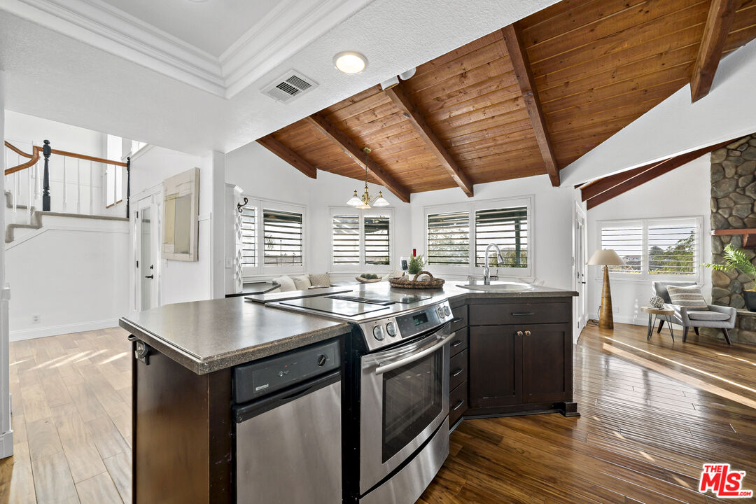 38675 Green Meadow Road Temecula, CA 92592 - Photo 50 of 74 a kitchen with stainless steel appliances granite countertop a stove a sink and a refrigerator
