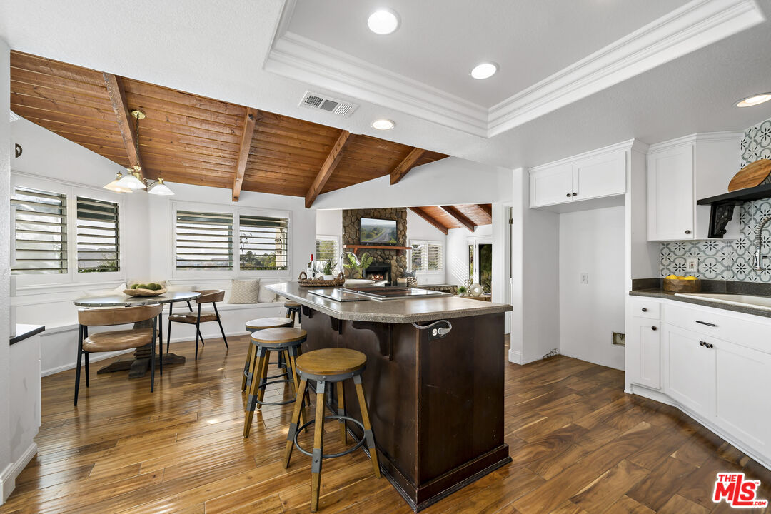 38675 Green Meadow Road Temecula, CA 92592 - Photo 51 of 74 a kitchen with stainless steel appliances granite countertop a stove a sink dishwasher and a refrigerator with wooden floor