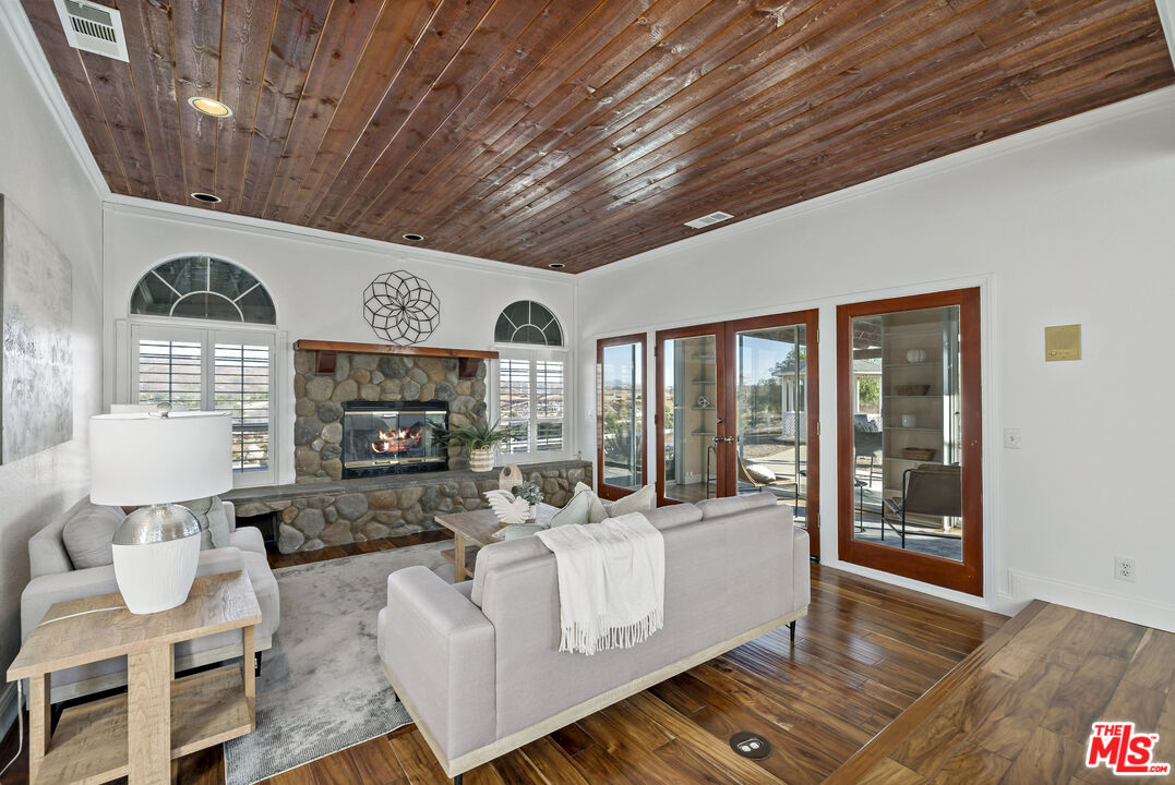 38675 Green Meadow Road Temecula, CA 92592 - Photo 54 of 74 a living room with furniture a fireplace and a table