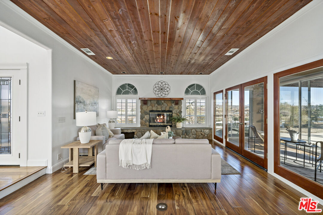 38675 Green Meadow Road Temecula, CA 92592 - Photo 55 of 74 a living room with furniture floor to ceiling window and wooden floor