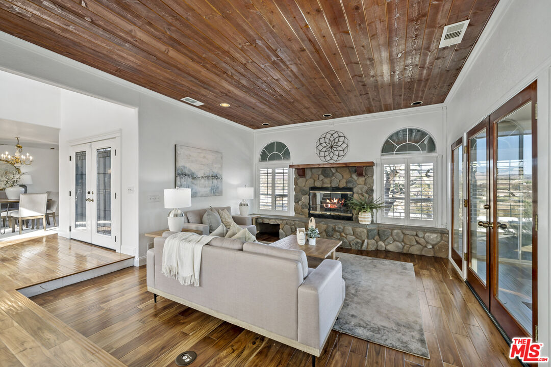 38675 Green Meadow Road Temecula, CA 92592 - Photo 56 of 74 a living room with furniture a fireplace and a table