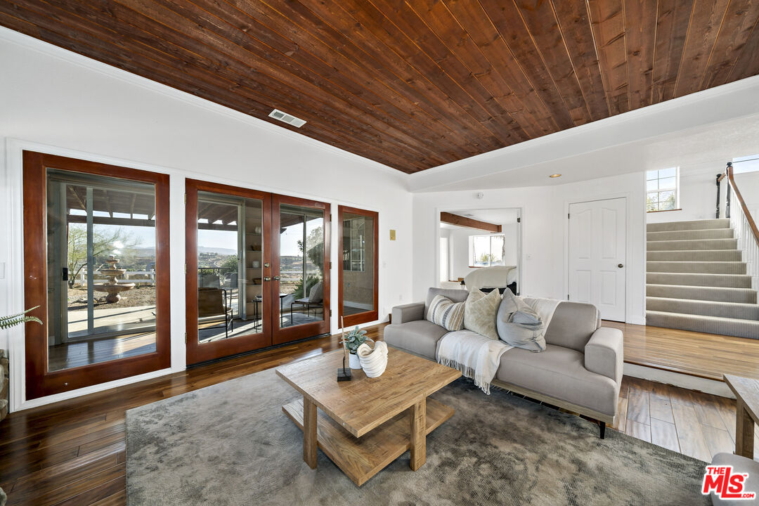 38675 Green Meadow Road Temecula, CA 92592 - Photo 58 of 74 a living room with furniture and a floor to ceiling window