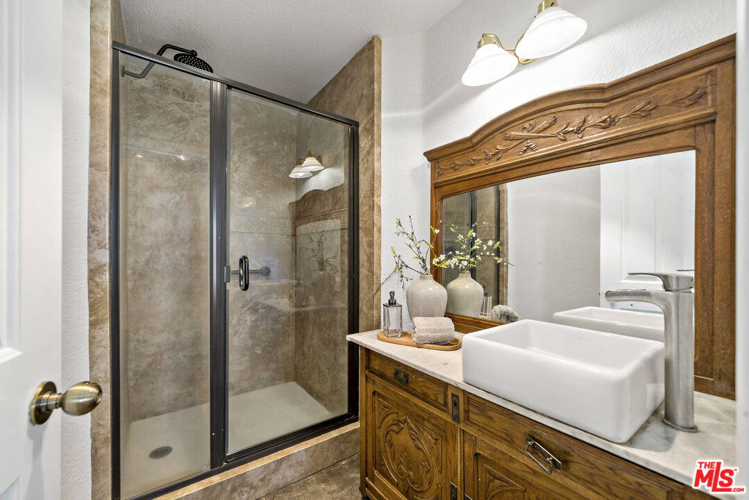 38675 Green Meadow Road Temecula, CA 92592 - Photo 66 of 74 a bathroom with a shower sink and mirror