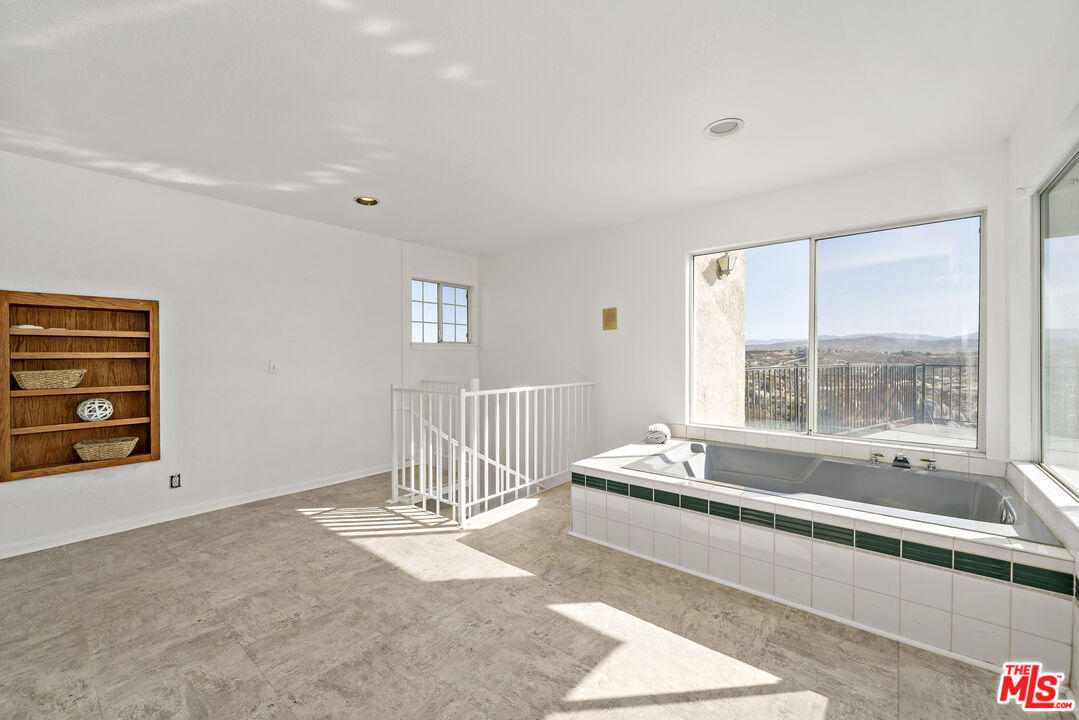 38675 Green Meadow Road Temecula, CA 92592 - Photo 71 of 74 a spacious bedroom with a bed and a window