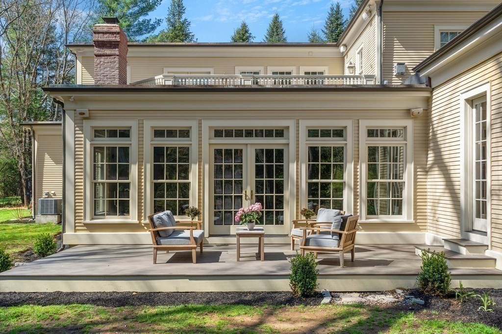 75 Oxbow Road Concord, MA 01742 - Photo 11 of 41 a front view of a building with garden and patio