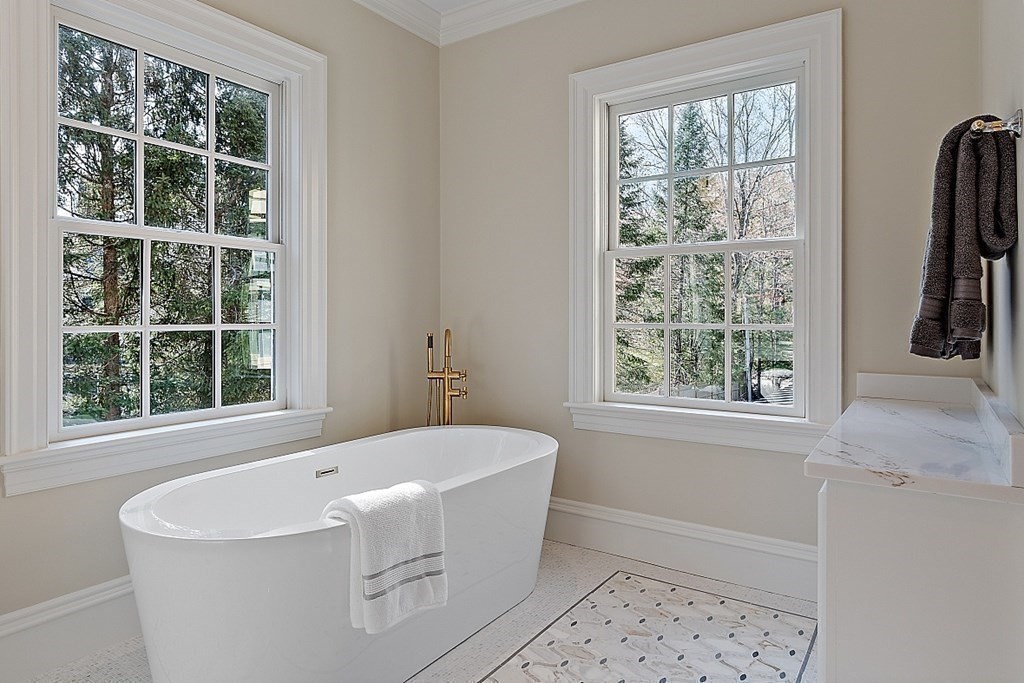75 Oxbow Road Concord, MA 01742 - Photo 25 of 41 a white bath tub sitting in a bathroom next to a window