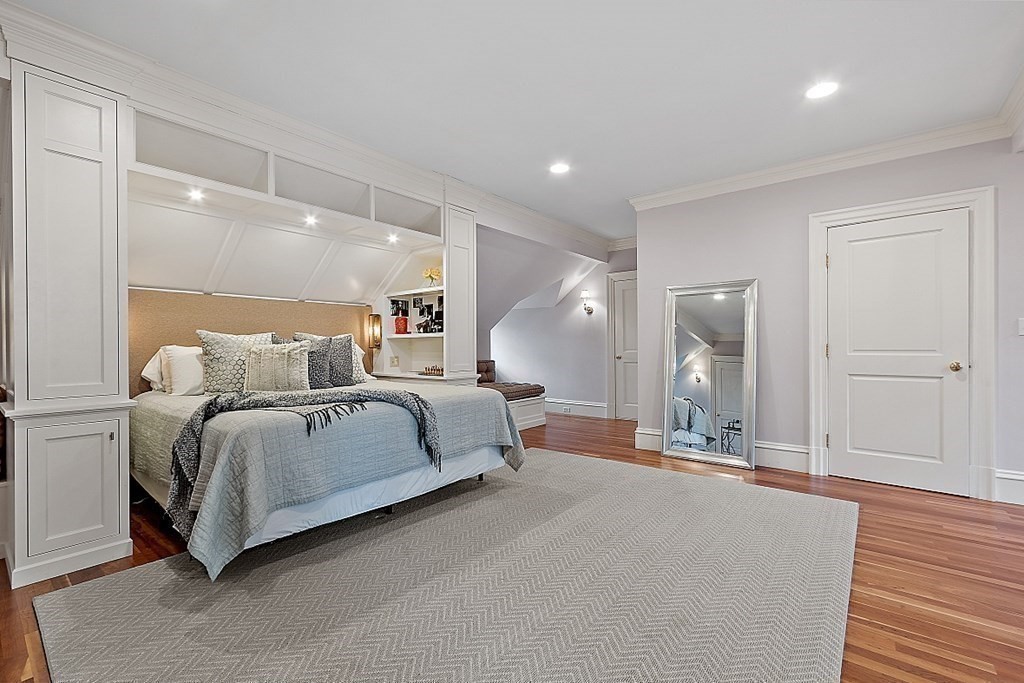 75 Oxbow Road Concord, MA 01742 - Photo 33 of 41 a spacious bedroom with a bed a mirror and lamp
