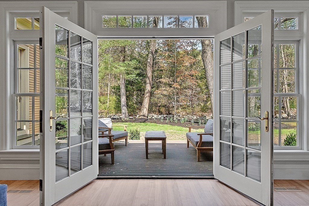 75 Oxbow Road Concord, MA 01742 - Photo 10 of 41 a view of dining room with wooden floor and floor to ceiling window