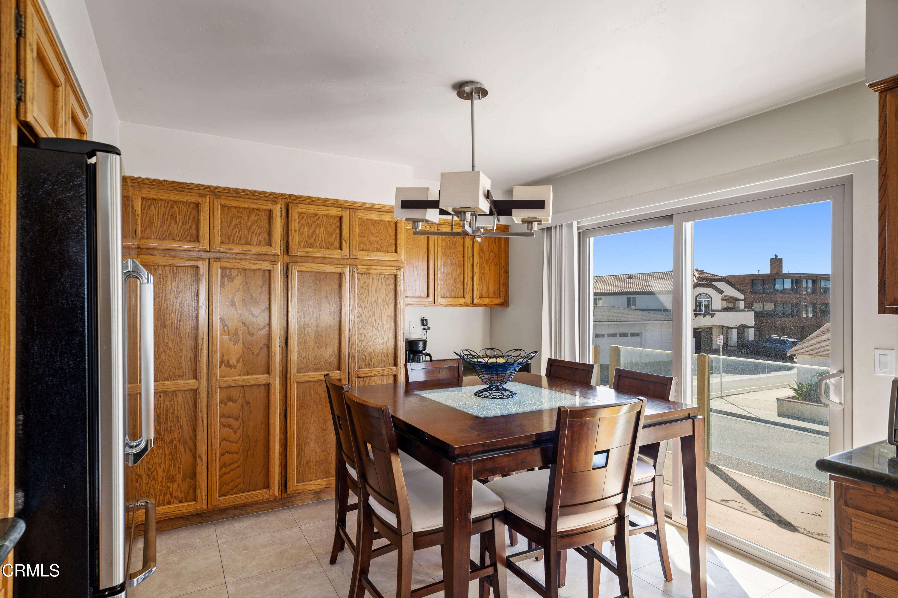1150 Mandalay Beach Road Oxnard, CA 93035 - Photo 16 of 48 a dining room with furniture a chandelier and window